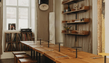 wiercinski-studio builds cozy 'amator' restaurant around modular oak table in copenhagen
