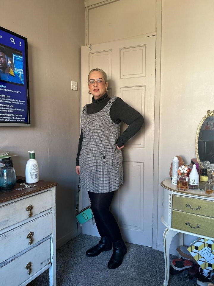 Woman in a black and white dress and black boots.