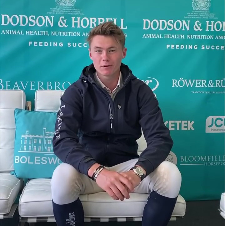 Young show jumper sitting on a couch.