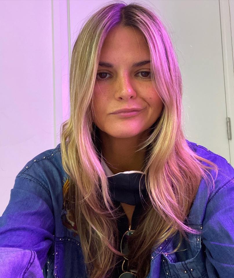 Portrait of a woman with long blonde hair wearing a denim jacket.
