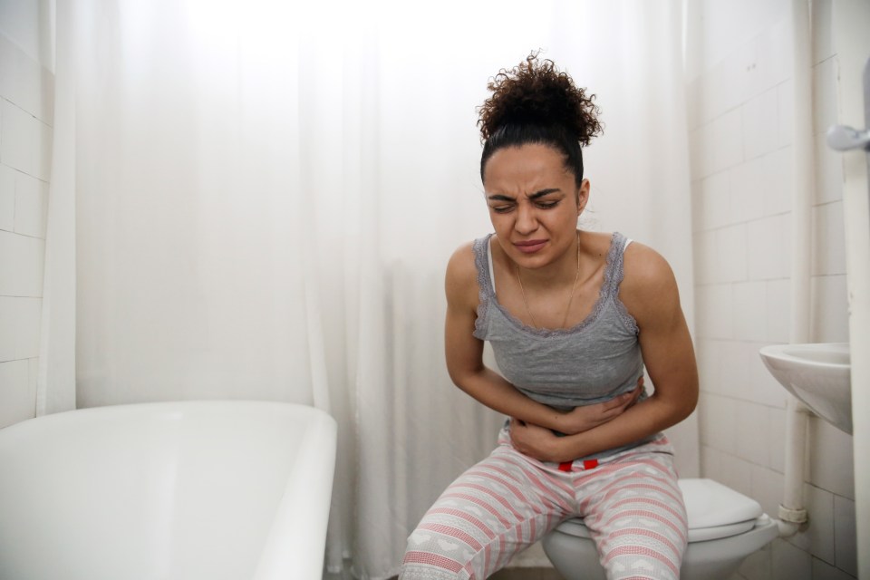 Young woman experiencing diarrhea or food poisoning.