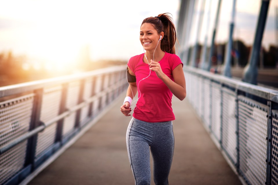Young woman jogging on a bridge.