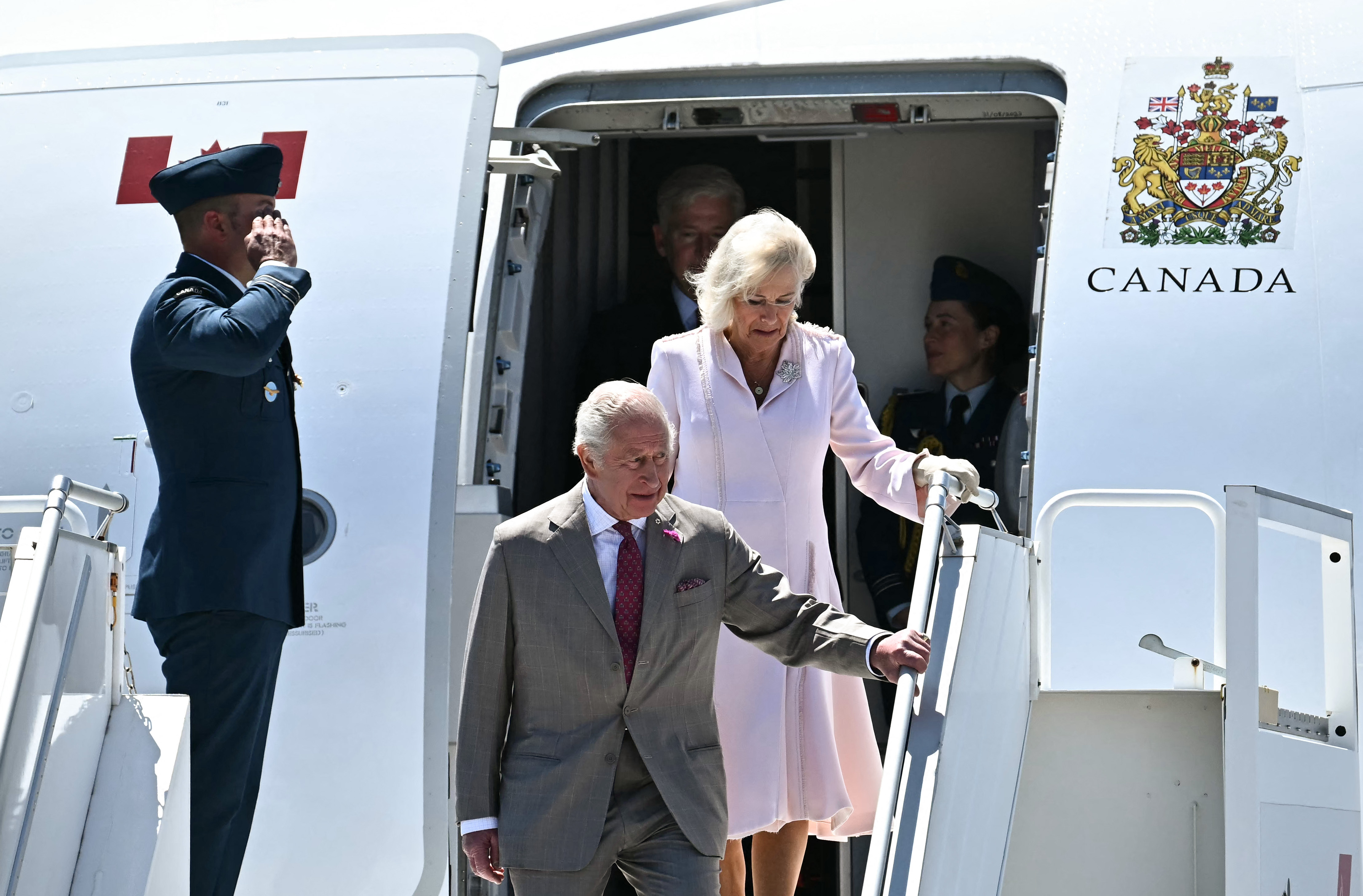 King Charles III and Queen Camilla disembarking a plane in Ottawa.