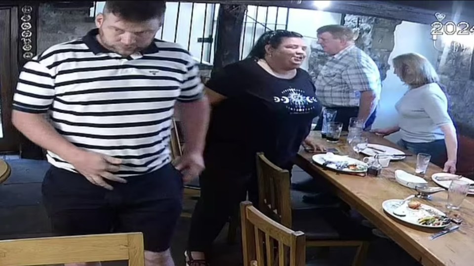 Security camera footage of a family at a restaurant table.