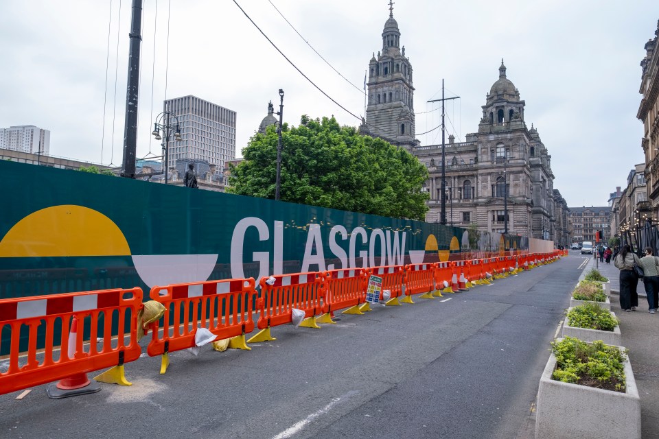 Fencing and signage around Glasgow's George Square during redevelopment.