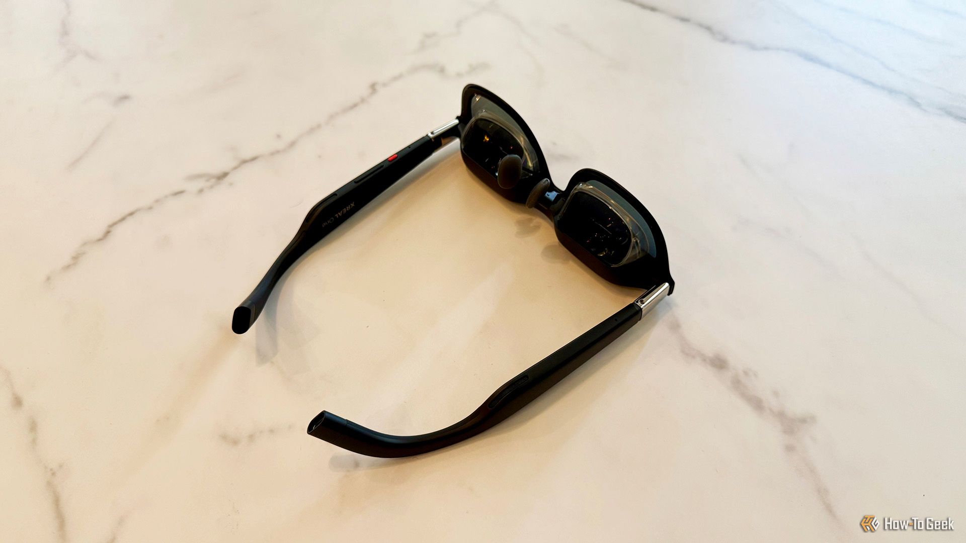 XREAL One AR Glasses upside down on a table.