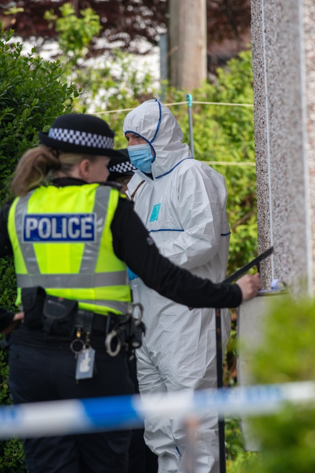 Police officer and forensic investigator at a crime scene.