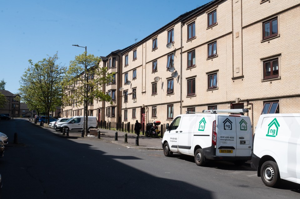 Apartment building on Killearn Street, Possilpark, with parked vans.