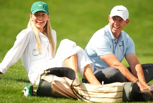 Rory McIlroy and his wife Erica Stoll sitting on the golf course