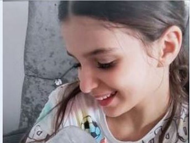 A family photo of Amelia who is 12 and is white with shoulder-length brown hair 