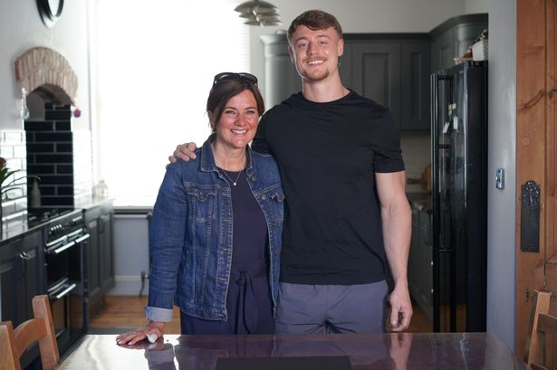 A mum and her son standing in a kitchen