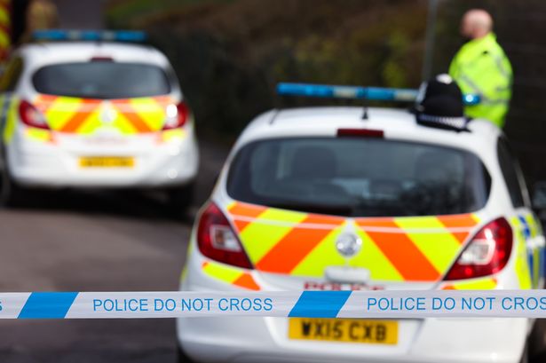 File image of police car and cordon