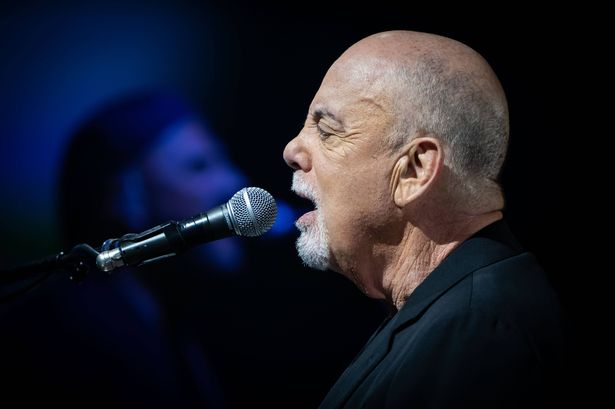 Billy Joel singing side view