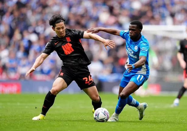 Peterborough United's Kwame Poku (right) and Birmingham City's Tomoki Iwata