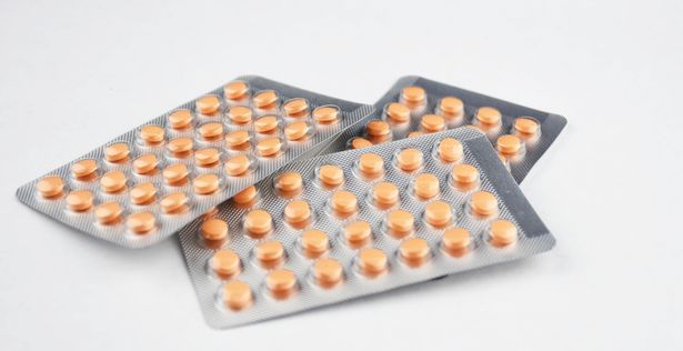 Blisters of hormonal oestrogen tablets on white background