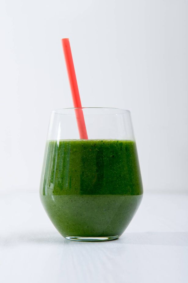 Green juice in cup with straw
