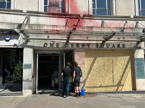 The One Derby Square building has had its front windows smashed, with red paint sprayed over the premises