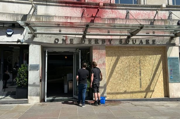 The One Derby Square building has had its front windows smashed, with red paint sprayed over the premises