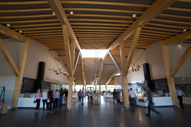 Inside the northbound services main catering hall under a grass-topped roof
