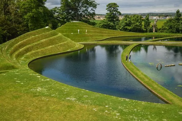 EDINBURGH, SCOTLAND - JUNE 08: People are seen walking among the Cells of Life at Jupiter Artland Sculpture garden on June 8, 2021 in Edinburgh, United Kingdom. The Jupiter Artland Scupture Garden is an award-winning contemporary sculpture park founded by philanthropist art collectors Robert and Nicky Wilson, in 2009. Coronavirus lockdown easing across Scotland coupled with warm weather has seen visitors return to outdoor attractions. (Photo by Peter Summers/Getty Images)
