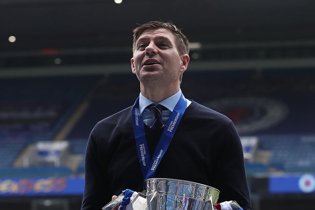 GLASGOW, SCOTLAND - MAY 15: Rangers Manager Steven Gerrard is seen with the Scottish Premiership trophy during the Scottish Premiership match between Rangers and Aberdeen on May 15, 2021 in Glasgow, Scotland. Sporting stadiums around the UK remain under strict restrictions due to the Coronavirus Pandemic as Government social distancing laws prohibit fans inside venues resulting in games being played behind closed doors.  (Photo by Ian MacNicol/Getty Images)