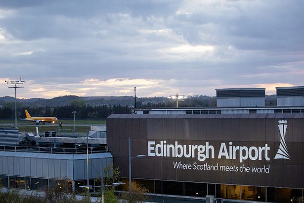 A cargo plane operated by DHL taxis on the tarmac at Edinburgh Airport in Edinburgh