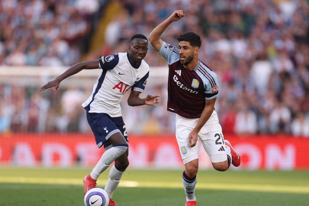 Pape Matar Sarr competes with Aston Villa's Marco Asensio for possession.