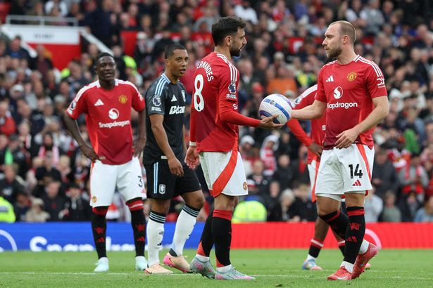 Bruno Fernandes gives the ball to Christian Eriksen to take Manchester United's penalty.