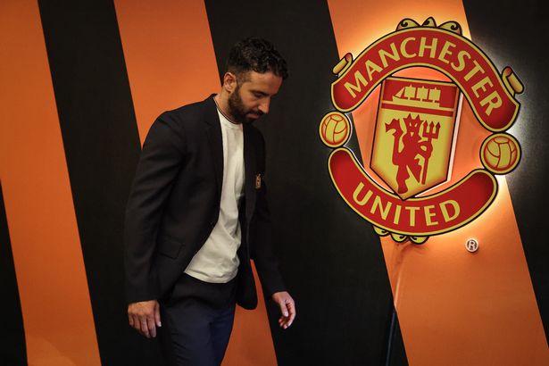 Manchester United head coach Ruben Amorim passes the Manchester United crest on the wall inside the tunnel at the San Mames Stadium.