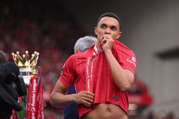 LIVERPOOL, ENGLAND - MAY 25: Trent Alexander-Arnold of Liverpool kisses the emblem of Liverpool on his shirt as he  celebrates as Liverpool are crowned the Champions of the Premier League for the 2024/25 Season following the Premier League match between Liverpool FC and Crystal Palace FC at Anfield on May 25, 2025 in Liverpool, England. (Photo by Michael Regan/Getty Images/Getty Images For The Premier League)