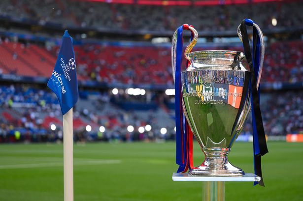 the UEFA Champions League logo on a corner flag and the UEFA Champions League trophy 