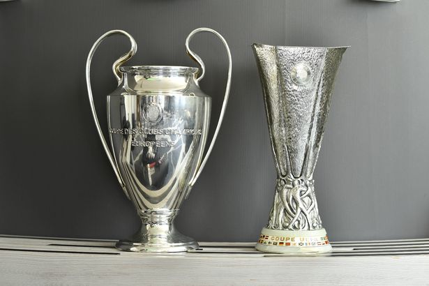 The Champions League and Europa League trophies stand side-by-side.