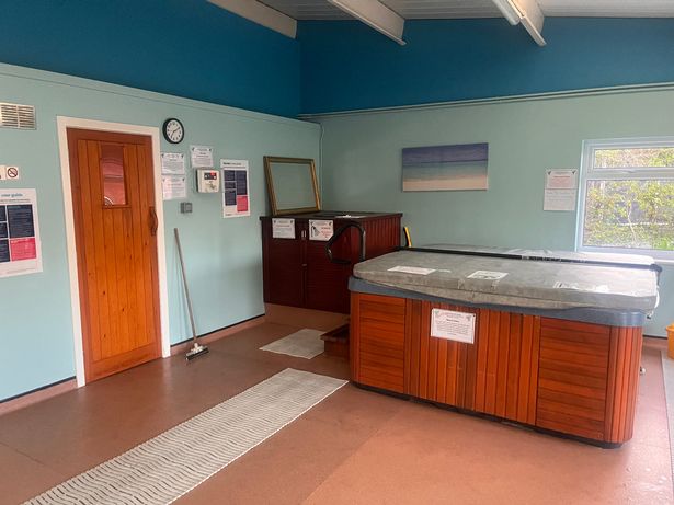 Behind the wooden door is a sauna and in front is the heated swimming pool, where members have to be naked to go in both.
