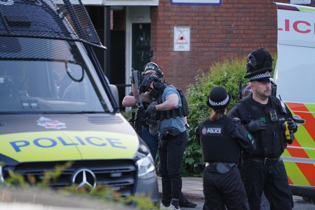 Police at the scene of the raid