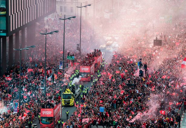 Parting of the Red Sea - Thousands of jubilant supporters line The Strand in celebration as Liverpool FC players parade the Champions League Trophy