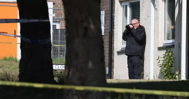 Forensic officers in attendance as a murder investigation takes place in Bury