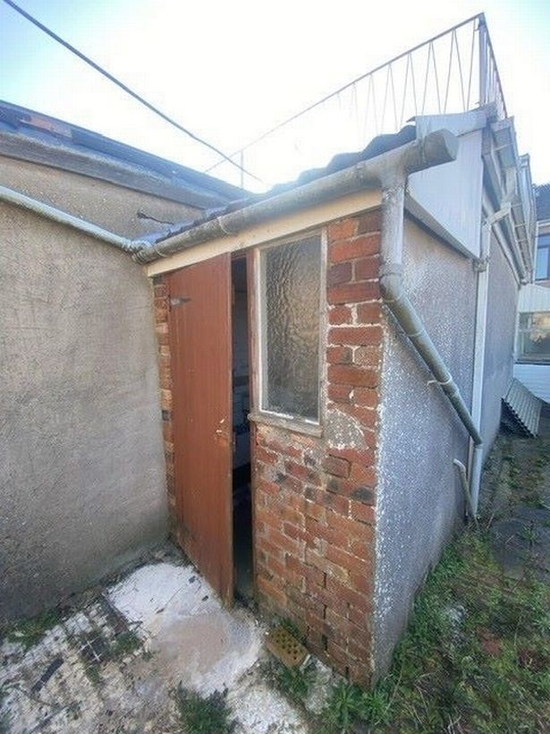 The tiny building going to auction has a front door and window and that's it, so a tour inside won't take long 