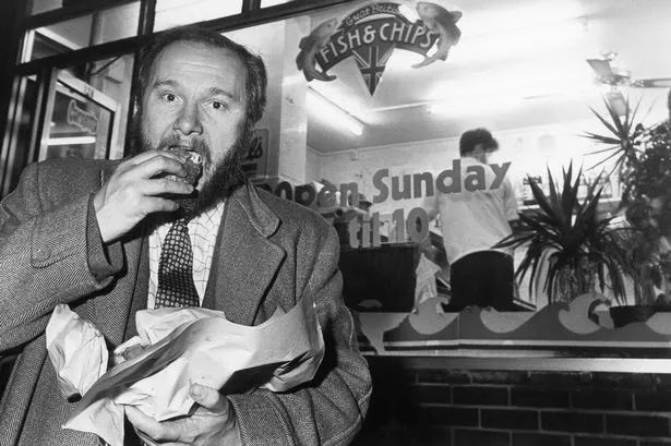 Liverpool Echo reporter Joe Riley tries out the food at Skipper's fish and chip shop in Ormskirk, Lancashire, a candidate in the Liverpool Echo's Champion Chippy competition. 
9th November 1990.