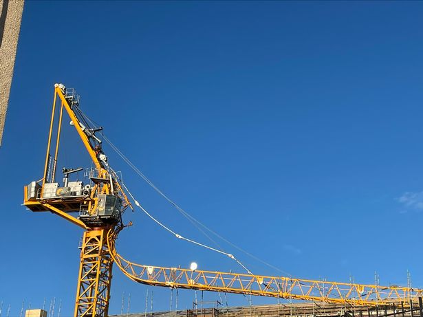 The scene after a section of crane gave way and fell onto the top of an apartment complex under construction