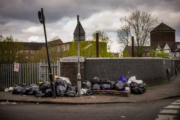 Uncollected household waste and rubbish blights the corner of a street as Birmingham council refuse collectors continue their strike on April 15, 2025