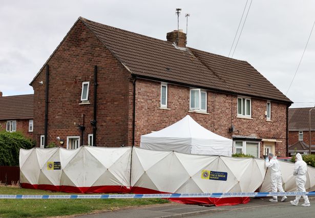 Forensic officers work at the scene of a fatal stabbing in Haydock 