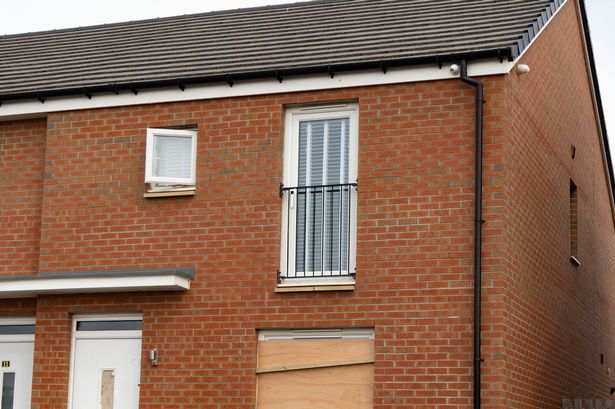 Windows on the property boarded up after the attack.