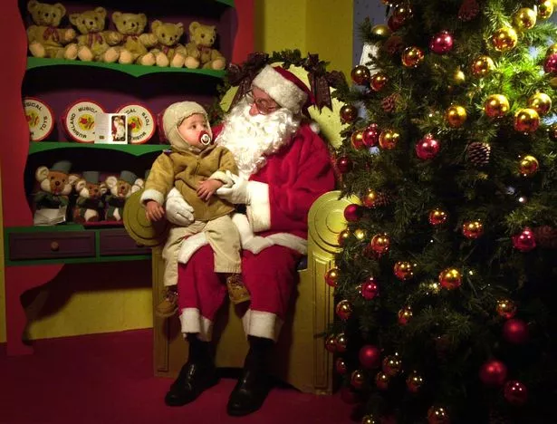 Father Christmas sits Callum Broadhurst on his knee at Lewis's grotto in Liverpool in 2002
