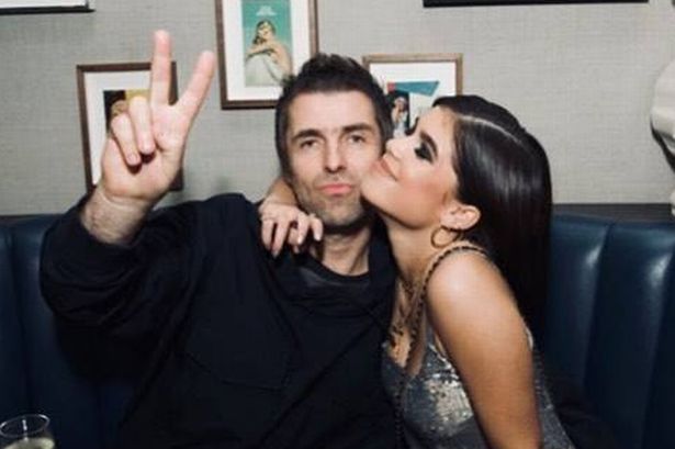 Liam Gallagher and Molly Moorish-Gallagher posing together in a booth.