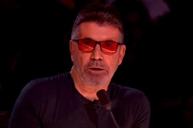 Simon Cowell in a black top on the Britain's Got Talent judging panel.