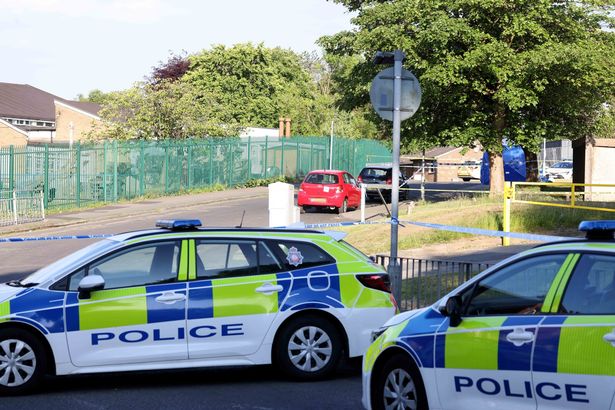 Police at the scene of the murder on Porritt Street, Bury 