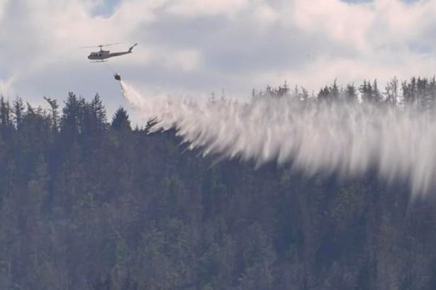 Helicopter dropping water