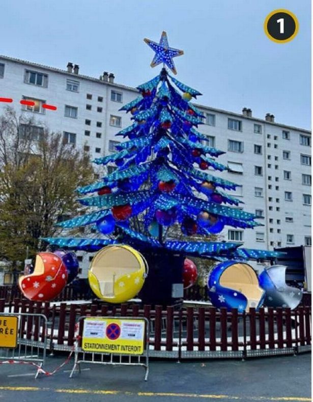 Blue Christmas tree-themed fairground ride with giant baubles for children to sit in at the bottom