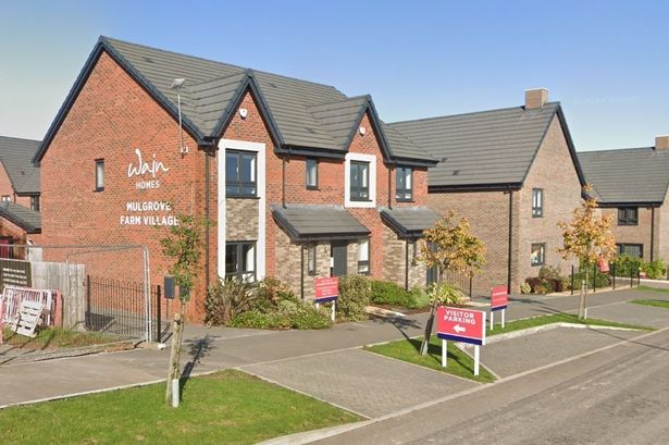 Detached show-house with developers' name on the side on new housing estate