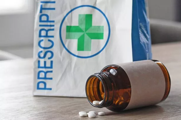 NHS packet with a pill bottle on a counter